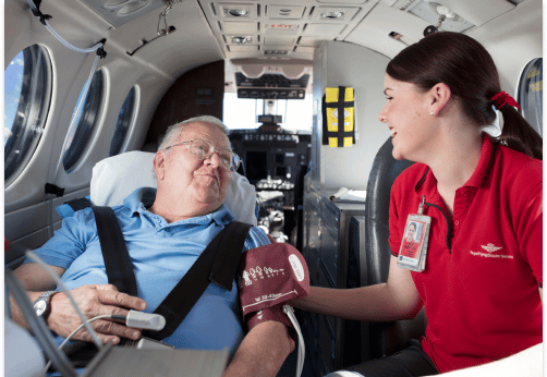 RFDS Nurse overlooking a patient inside an RFDS Aircraft