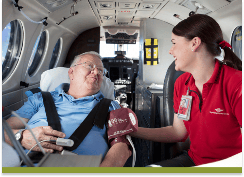 RFDS Nurse overlooking a patient inside an RFDS Aircraft