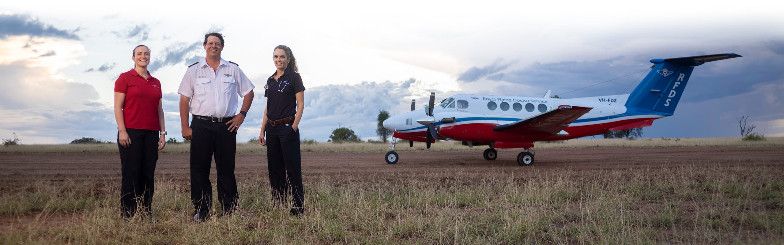 Royal Flying Doctor Service Pilot, Doctor and Nurse standing with an RFDS Aircraft in the background