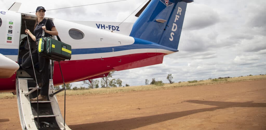 RFDS crew member loading medical equipment on the the Flying Doctor aircraft