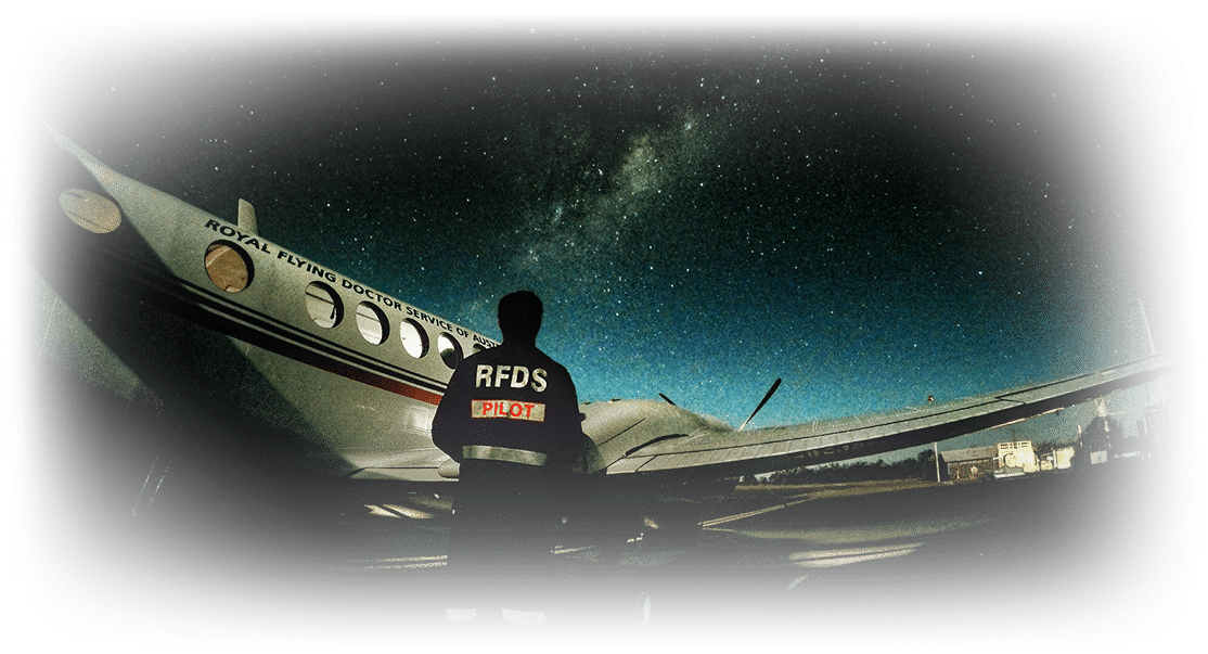 Royal Flying Doctor Pilot and Aircraft with the night sky above